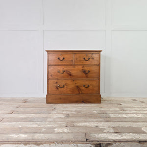 Early 20th century farmhouse style pine chest of drawers with four graduating drawers and brass swan neck handles
