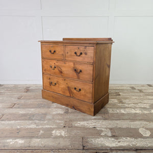 Antique pine storage chest with two short over two long drawers, brass swan neck handles and low upstand

