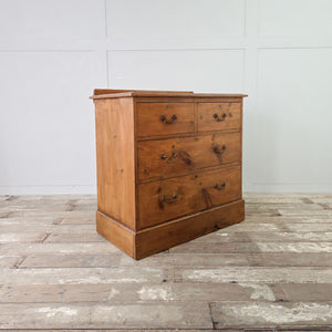 Early 20th century pine bedroom drawers with two over two layout, low upstand and brass swan neck handles