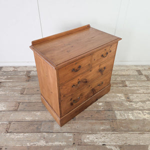 Antique rustic pine four drawer chest with graduating drawers, brass swan neck handles and plinth base

