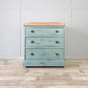 Early 20th century antique pine chest of drawers with a distressed duck egg blue painted finish and dark turned wooden knobs
