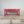 Antique pine farmhouse table with red-painted base and scrubbed pine top
