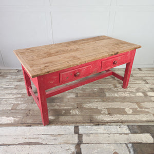 Antique farmhouse dining table in pine with red-painted base and two drawers
