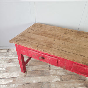 Large Victorian pine table with vibrant red base and scrubbed plank top
