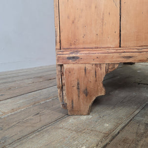 Antique pine hallway cupboard with panelled doors, turned knob, and original working lock, dating from the Georgian era.
