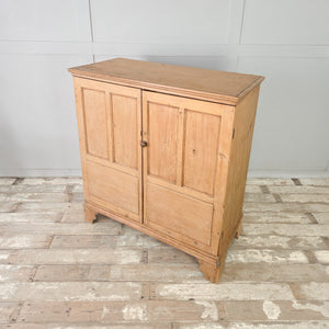 Early 19th century pine two door cupboard with a turned wooden knob, original lock and working key.
