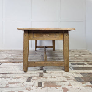 Antique rustic work table with chunky pine legs and low H-shaped stretcher