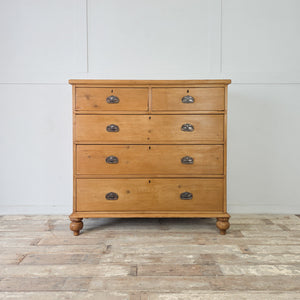 A good-sized late 19th century pine chest with five graduating drawers, each fitted with decorative original Art Nouveau style handles
