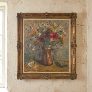 A large vintage oil on canvas still life depicting a bouquet of wildflowers in a copper pitcher, mounted in a substantial decorative gilt frame

