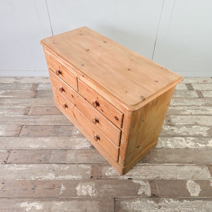 19th century Victorian pine chest of drawers with graduated storage drawers, turned knobs and centred escutcheons above each handle