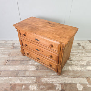 Antique pine bedroom drawers from the early 20th century, vintage farmhouse feel with three drawers and bun feet.

