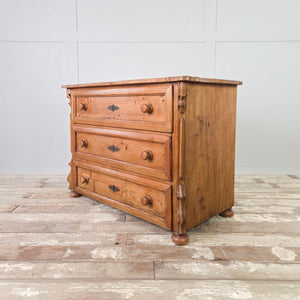 Antique vintage pine chest of drawers with three storage drawers, decorative metal escutcheons and bun feet base