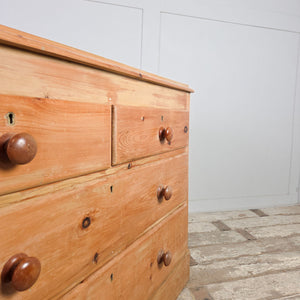 Victorian pine farmhouse chest of drawers with four storage drawers and contrasting wooden knobs.


