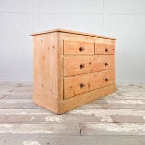 19th century Victorian pine country chest of drawers with turned wooden knobs and plinth base.