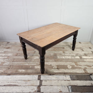 Antique farmhouse dining table with planked sycamore top and dark painted pine frame featuring a single drawer.
