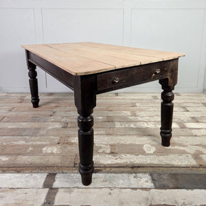 Antique Victorian dining table with a planked sycamore top, dark painted pine base and one utility drawer fitted with two glass knobs.
