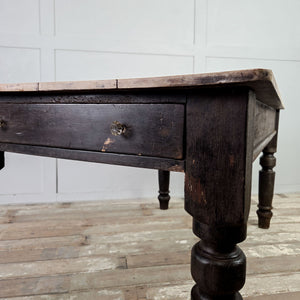 Antique farmhouse kitchen table with four plank sycamore top and dark painted pine base including one drawer.
