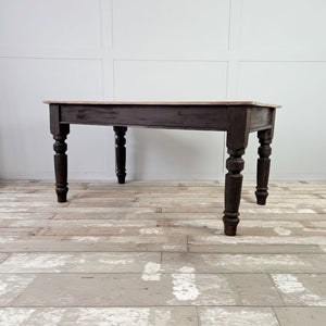 Victorian farmhouse dining table with planked sycamore top and dark painted base, including one drawer built into the apron with glass knobs.
