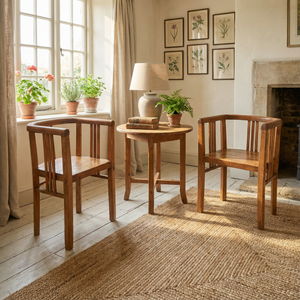 Pair of early 20th century pine tub chairs with classic barrel-back silhouette, vertical slatted sides and back, continuous curved top rail, deep seats and square-set legs.
