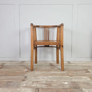 Early 20th century country pine tub chair pair with curved wrap-around rail, vertical slatted supports to back and sides, deep pine seats and square-set legs, rustic occasional seating.
