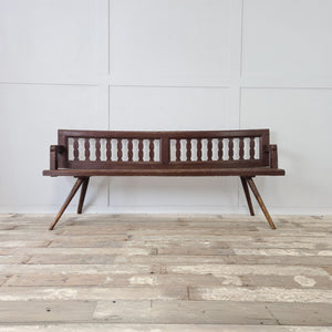 Primitive 19th century Romanian pine bench with cut-out slatted back panels and four splayed stick legs
