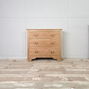 Antique style pine three drawer chest with brass handles and decorative bracket feet
