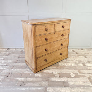19th century pine chest of drawers with five graduating drawers, turned wooden knobs and keyhole details
