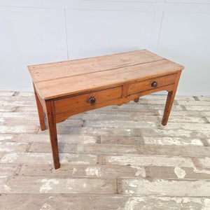 Rustic antique pine farmhouse table with two drawers, turned knobs and a timeworn planked top
